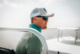 Model wearing the Bamboo Neck Gaiter in Ocean Blue. This fishing buff provides 35+ UPF sun protection.