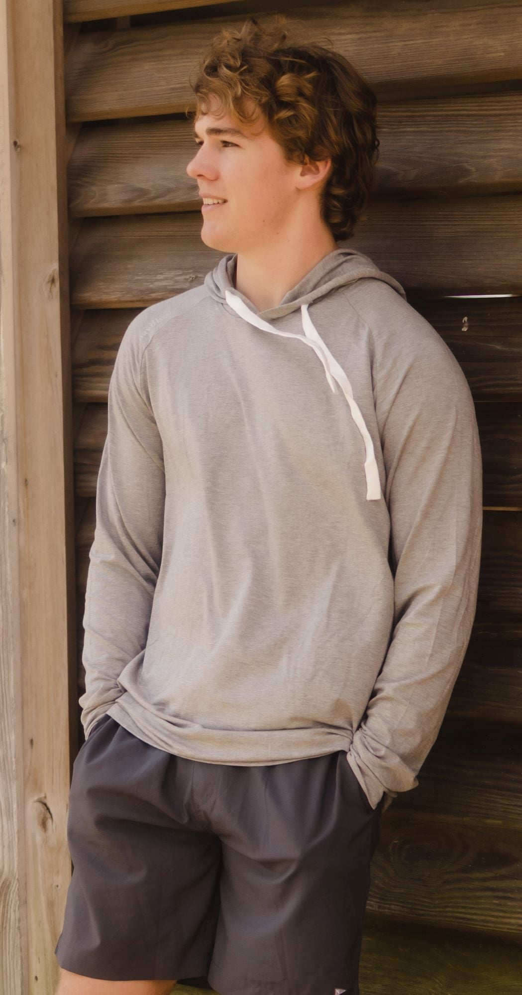 Model in the Classic Midweight Bamboo Hoodie in Heather Grey.