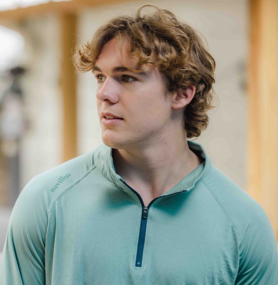 Model wearing The Captain's Performance Bamboo Quarter Zip in Sea Green.