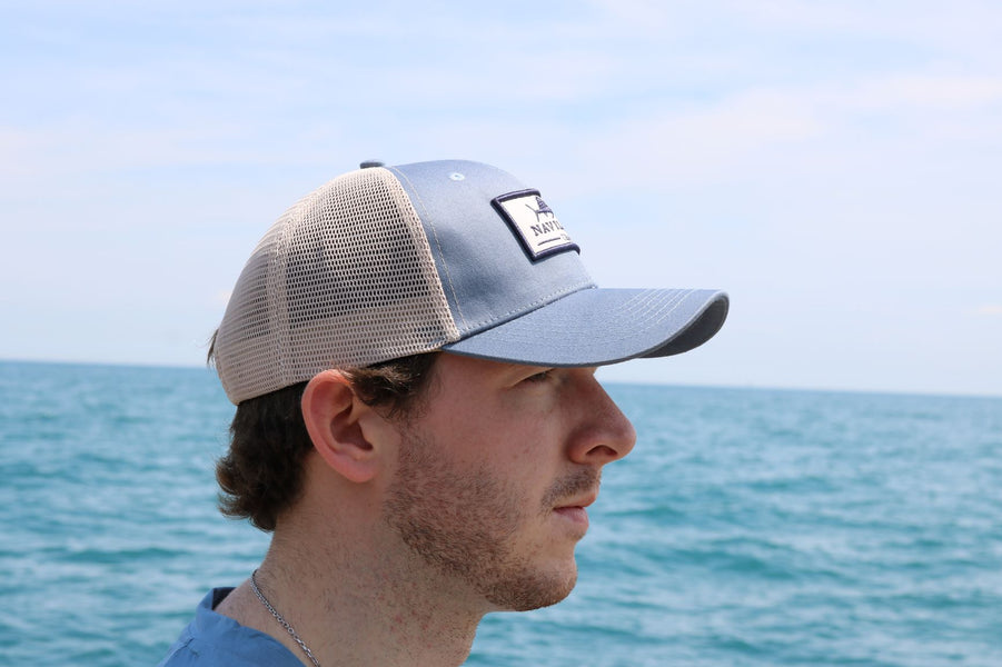 Model wearing the Deep Sea Snapback fishing cap. This fishing trucker cap has a mesh back.